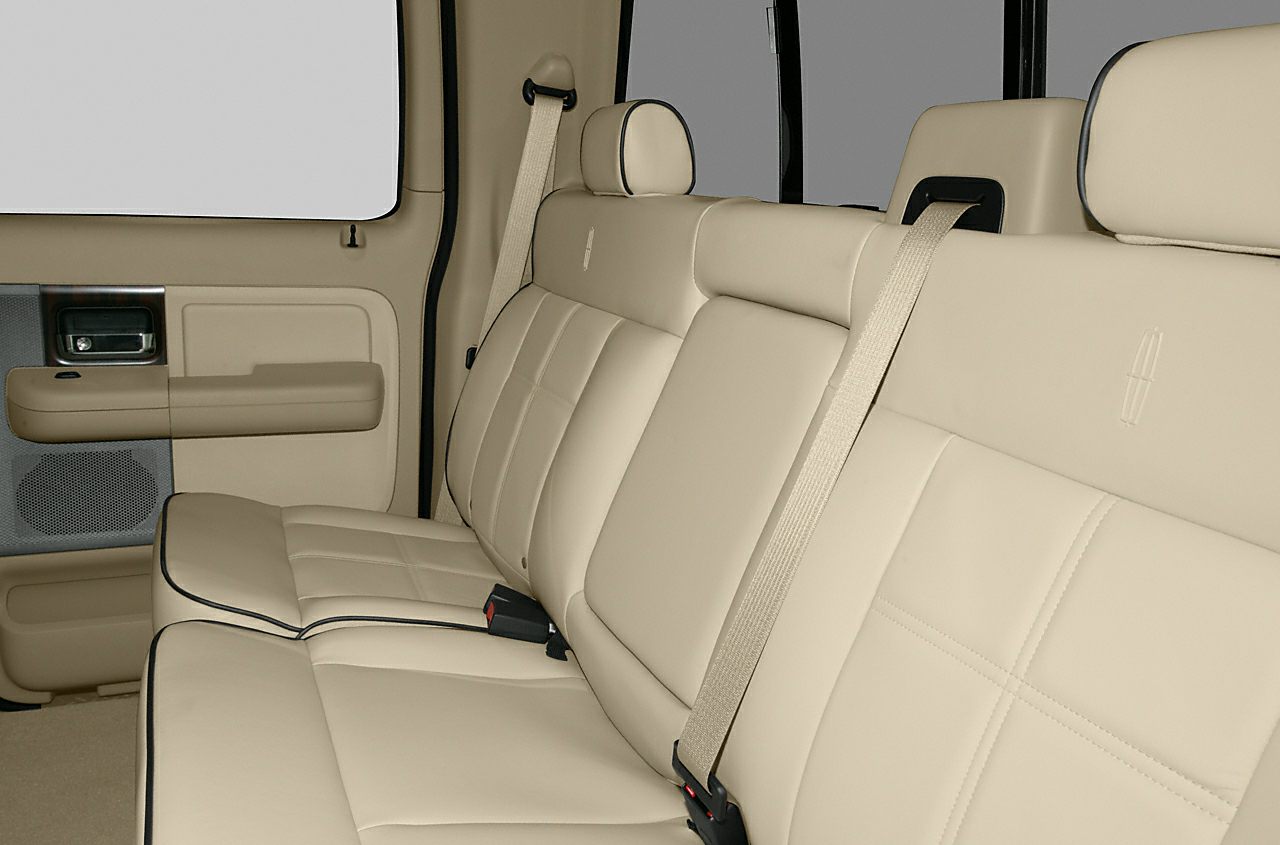 Beige leather rear bench seat with seatbelts and headrests