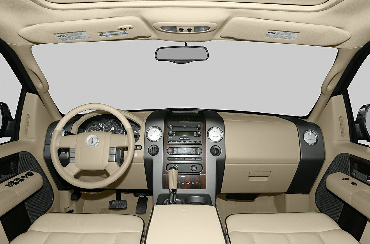 Beige leather interior with steering wheel, dashboard, and center console