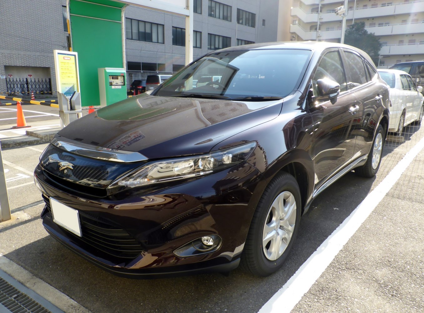Front side view of an SUV with sleek headlights and aerodynamic design.