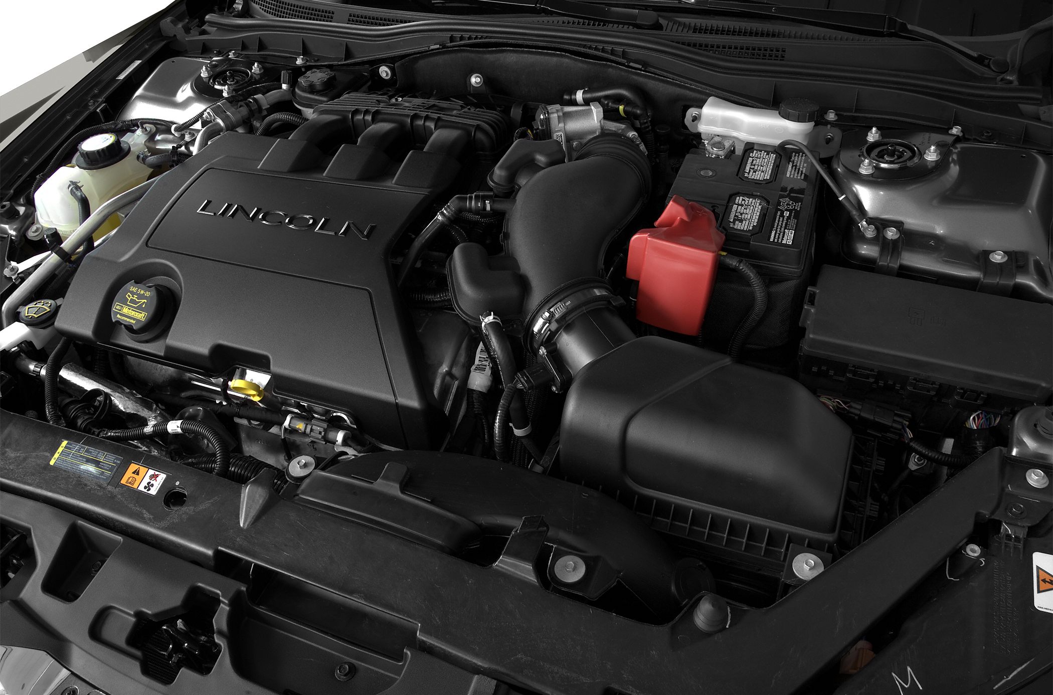 Engine cover, air intake system, and battery layout