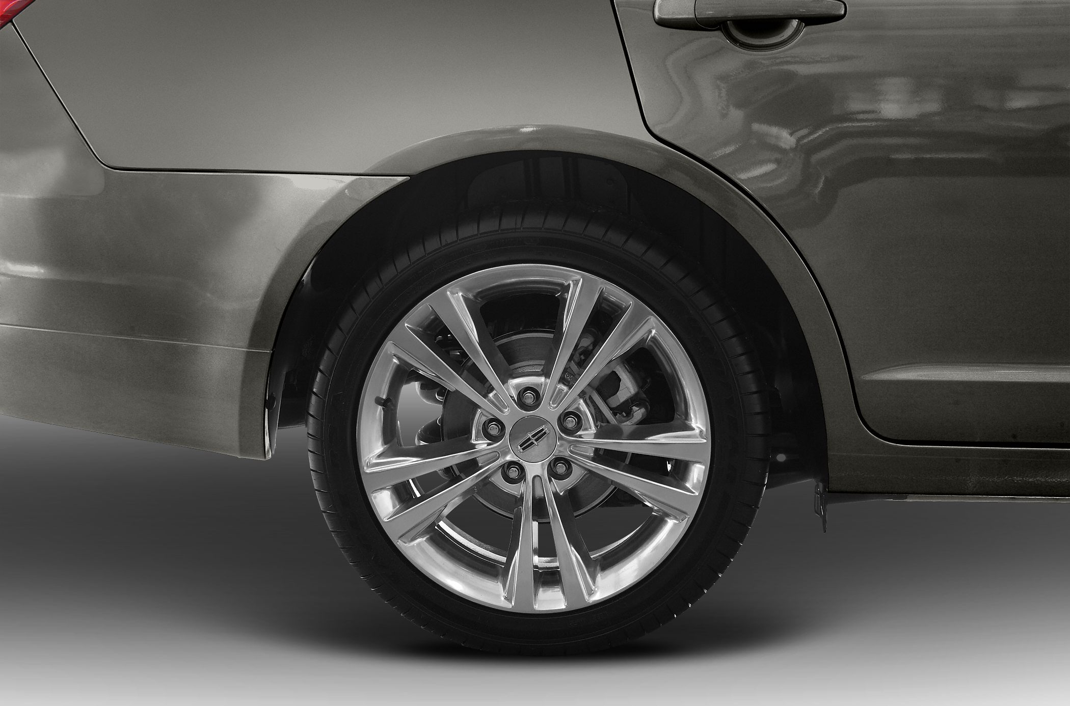 Polished alloy wheel and rear door section close-up