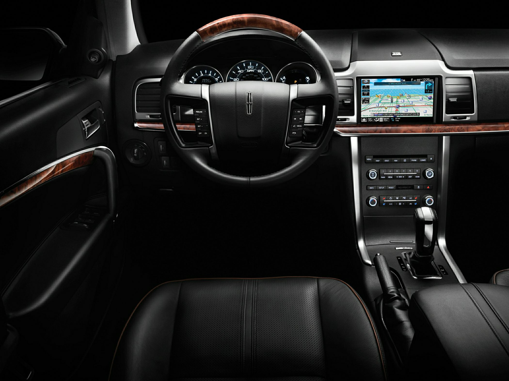 Leather steering wheel, digital gauges, wood trim, central navigation screen