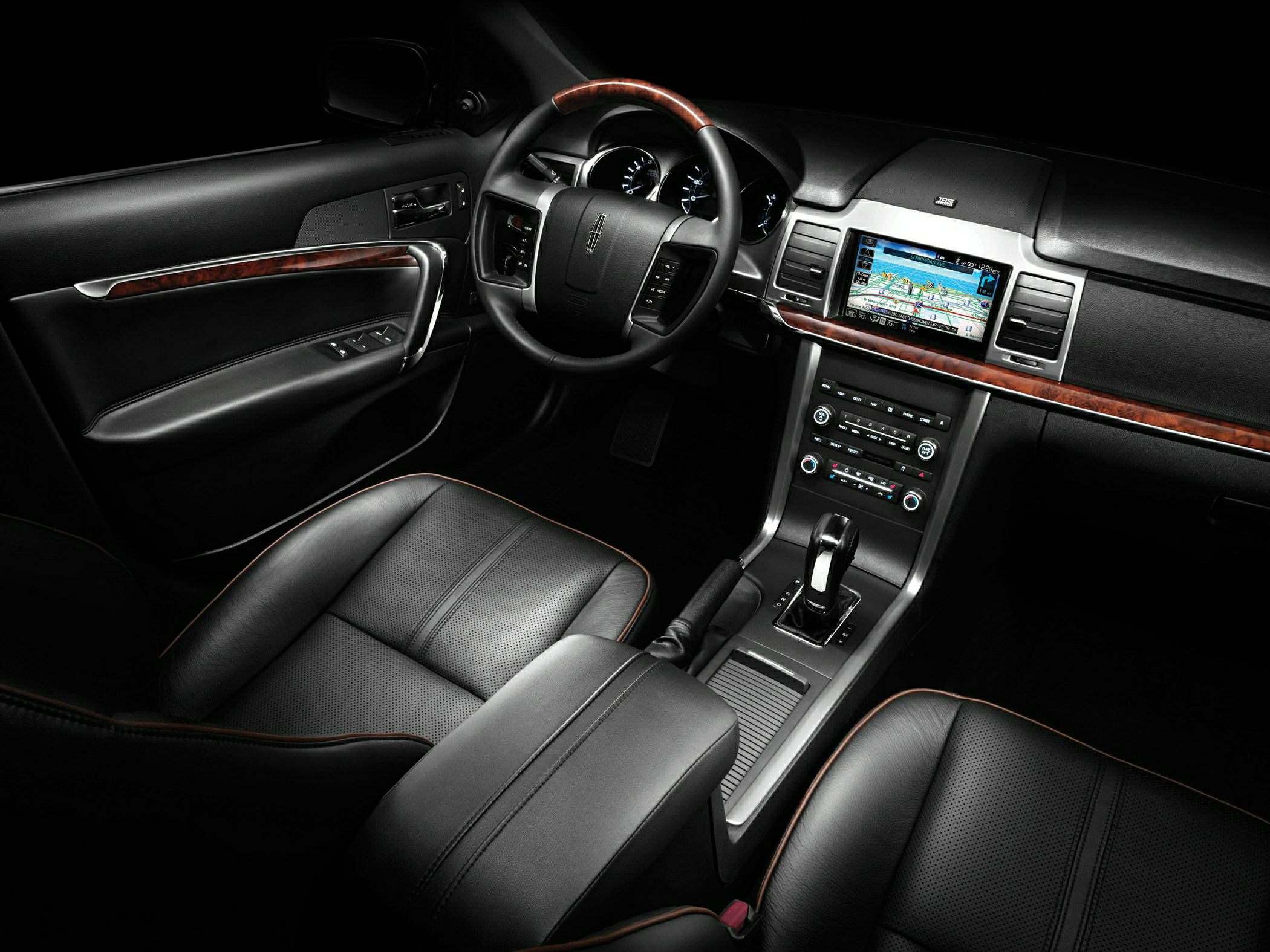 Black leather seats, wood trim, navigation screen, and steering wheel controls