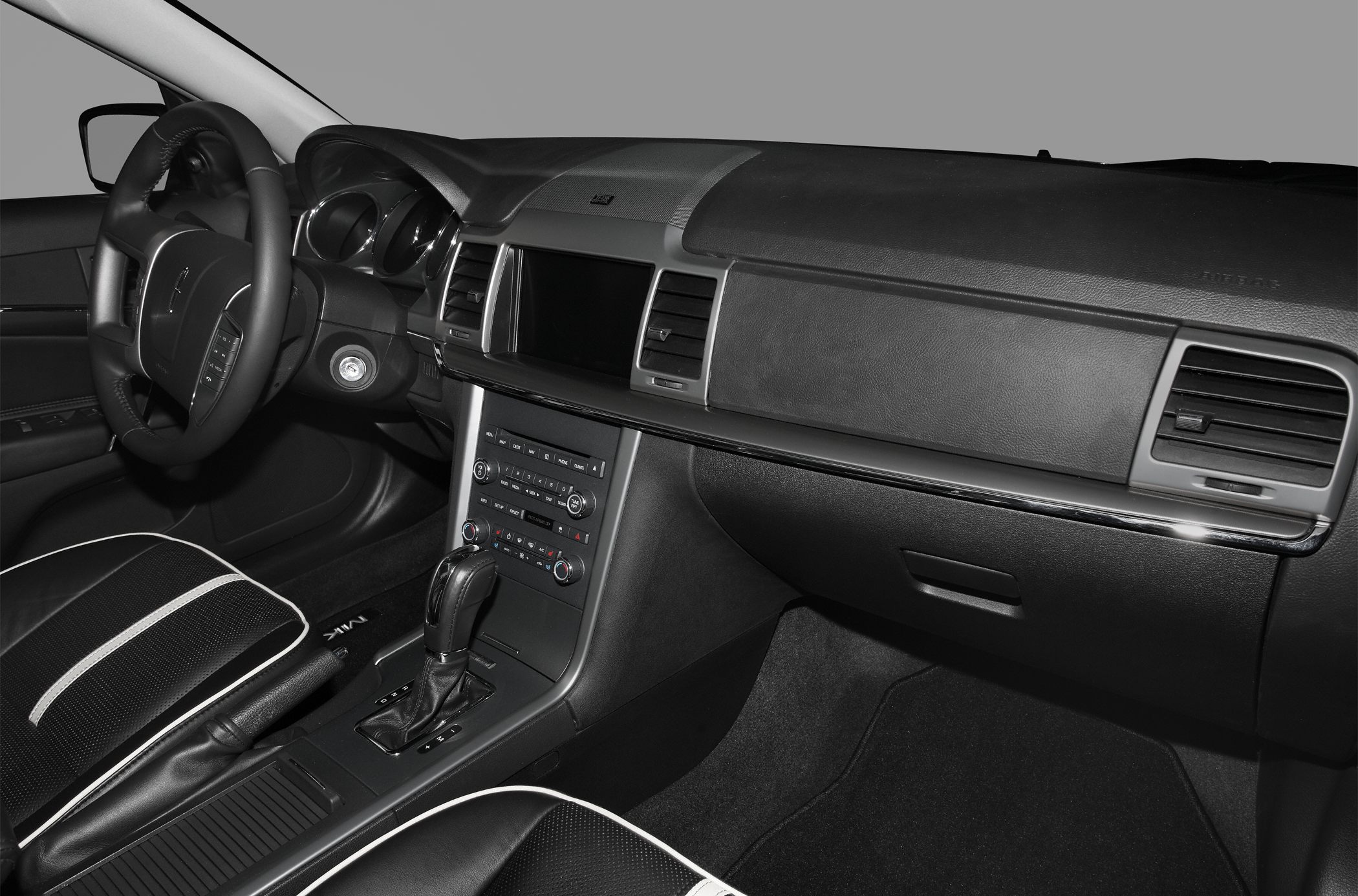 Car interior dashboard and center console with steering wheel and gear shift