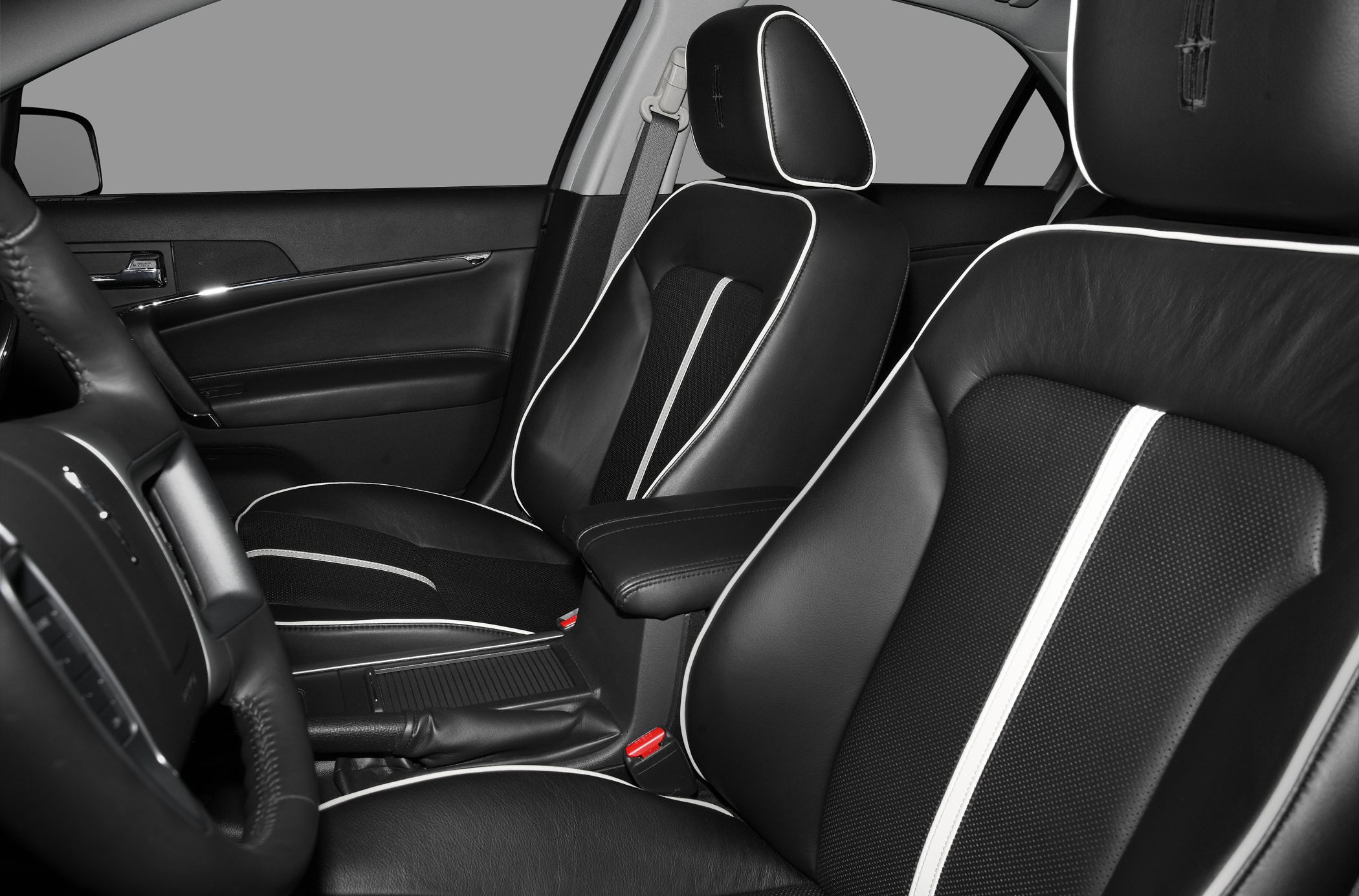 Black leather front seats with white piping and branded headrests