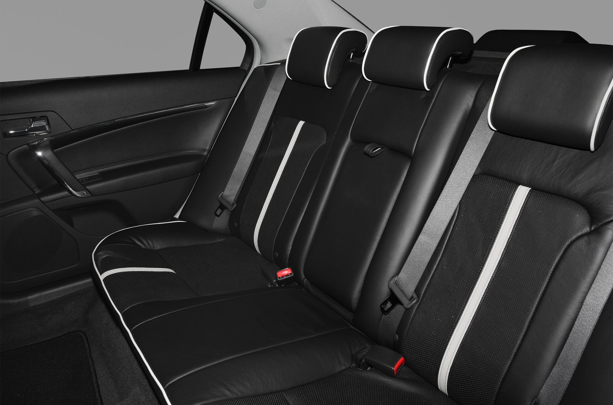 Black leather rear seats with white trimming and seat belts