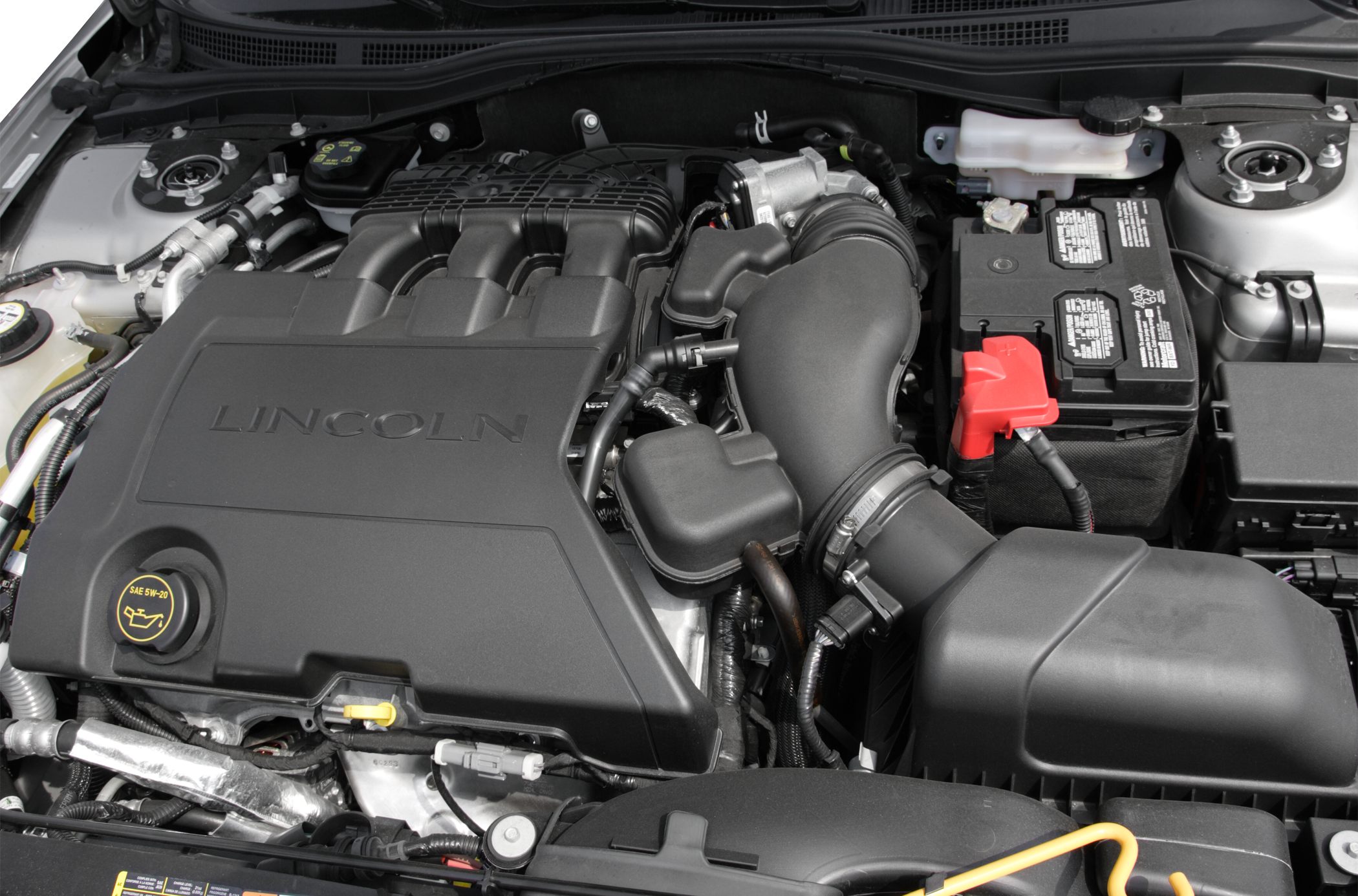 Engine bay components with Lincoln embossed cover and battery detail