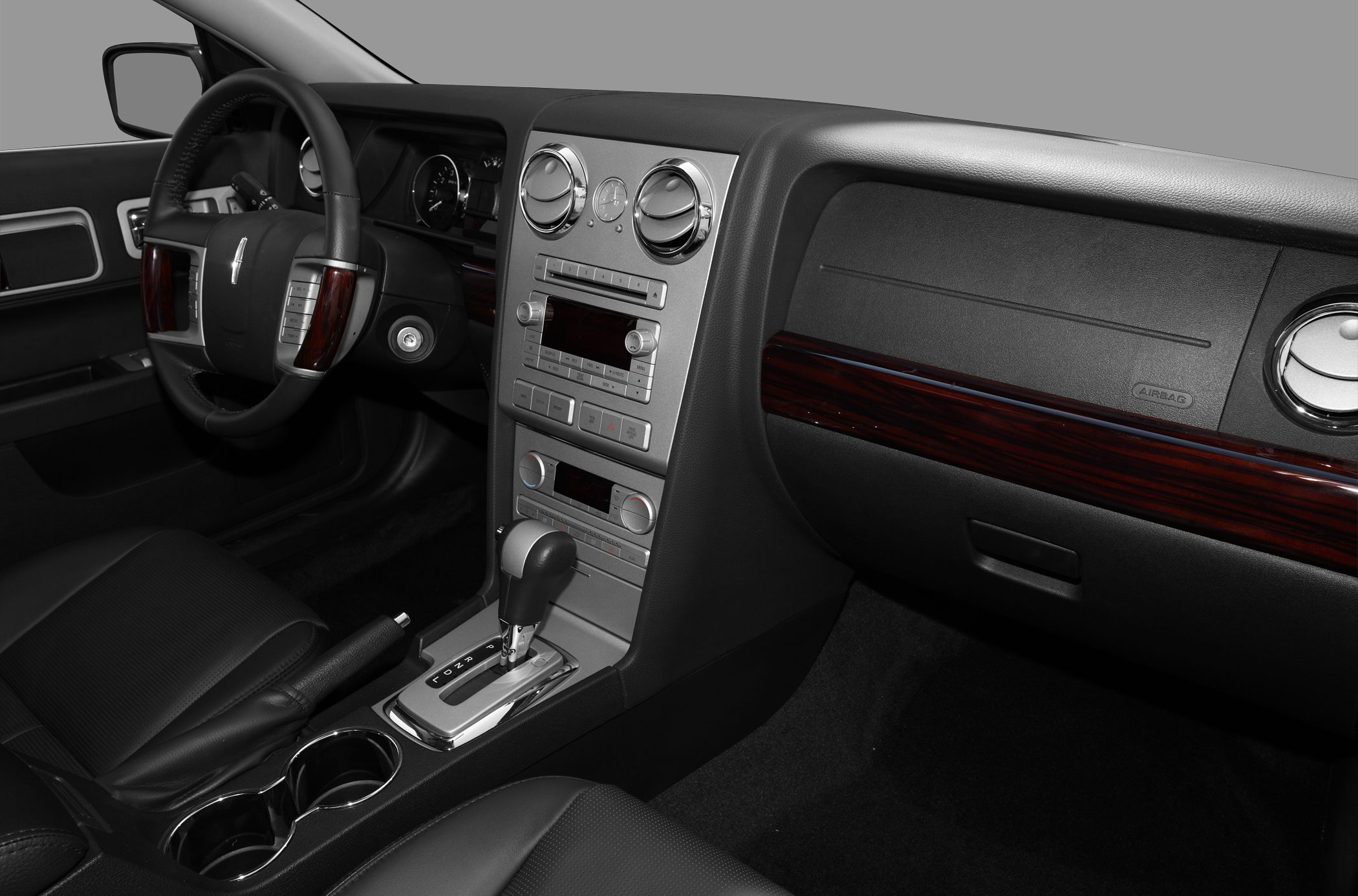 Wood-accented dashboard and center console with automatic gearshift and leather seating