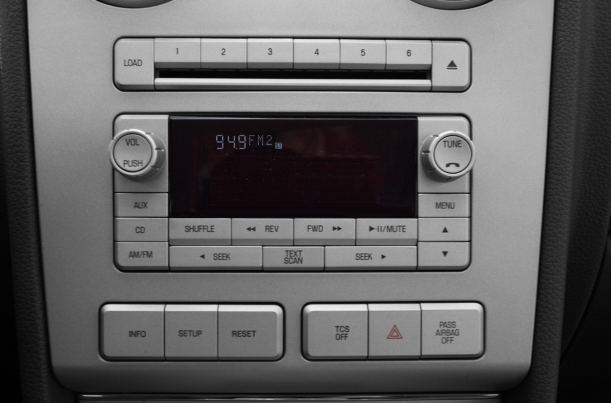 Car radio and control panel with buttons and knobs