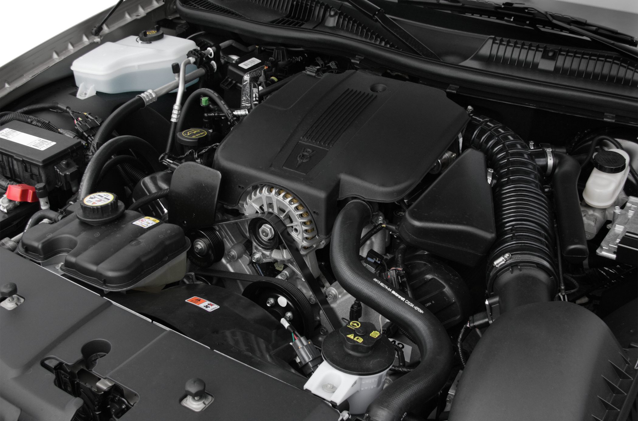 Close-up of engine bay components with visible alternator and hoses