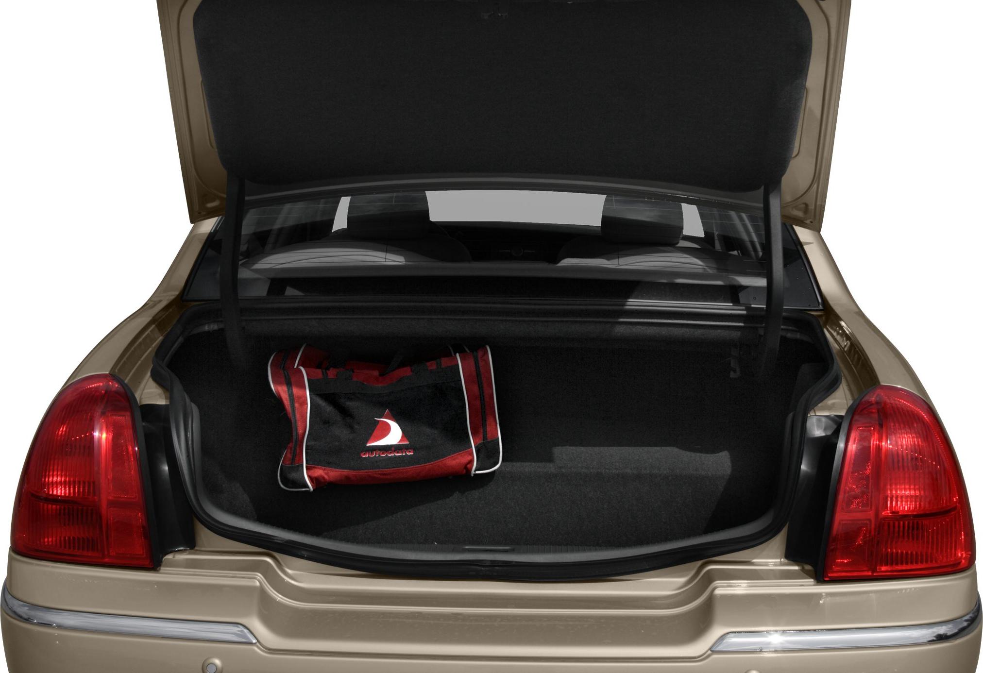 Open sedan trunk with spacious storage and a red-black bag inside