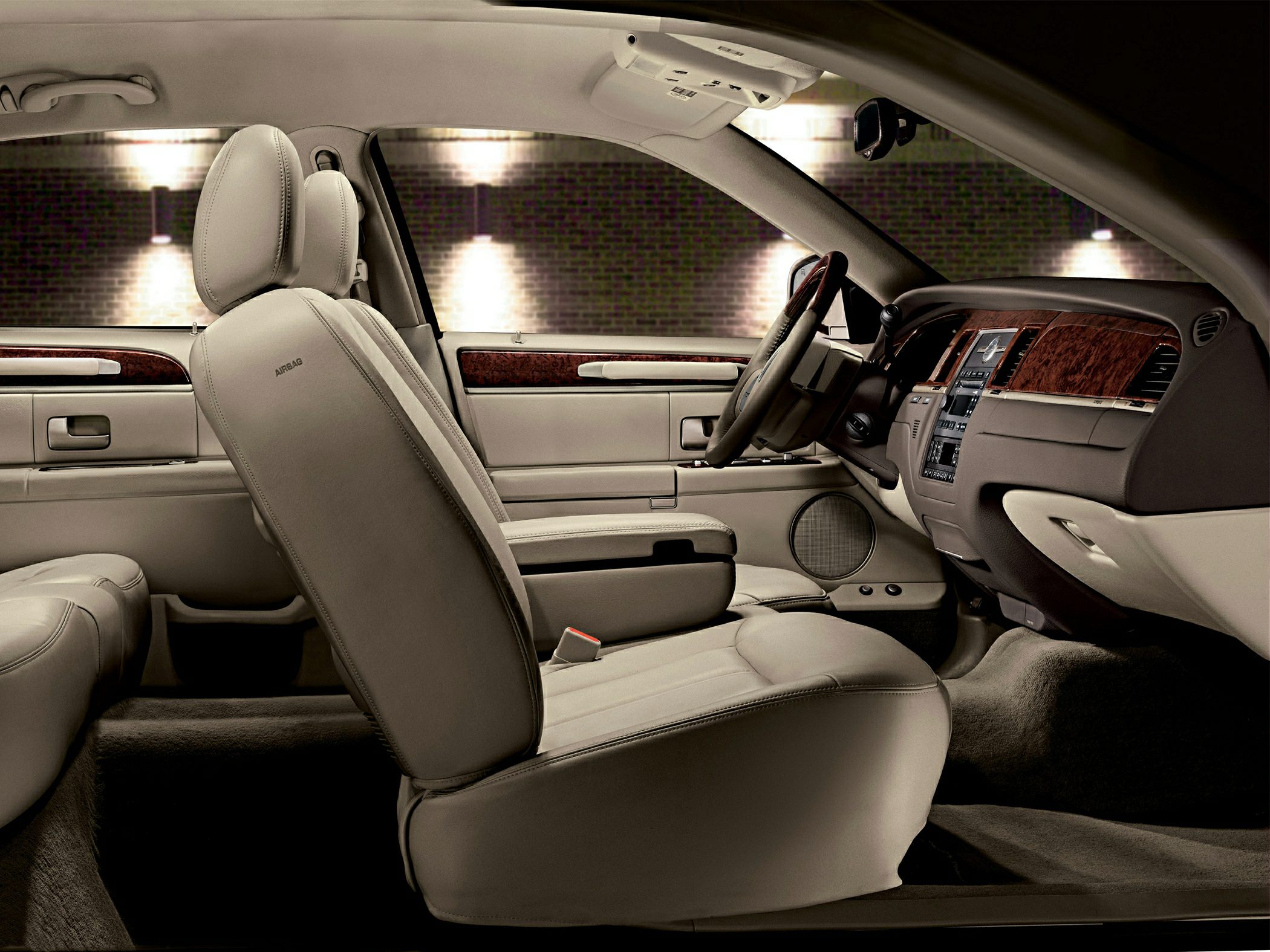 Beige leather seats and elegant wood trim dashboard interior
