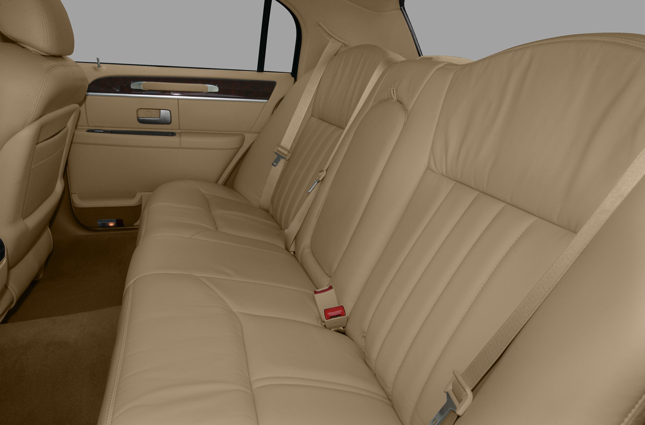 Beige leather rear seats with seat belts and door panel details