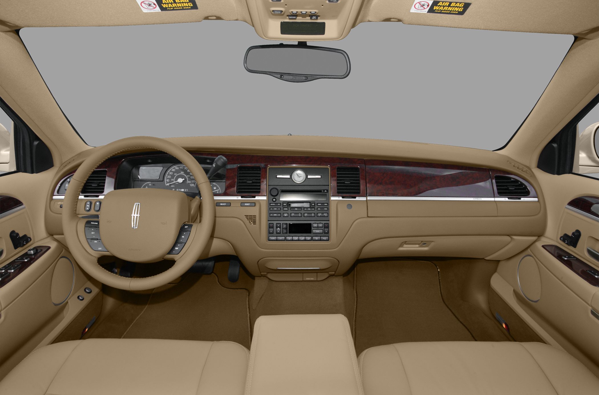 Beige leather interior with wood trim dashboard and steering wheel