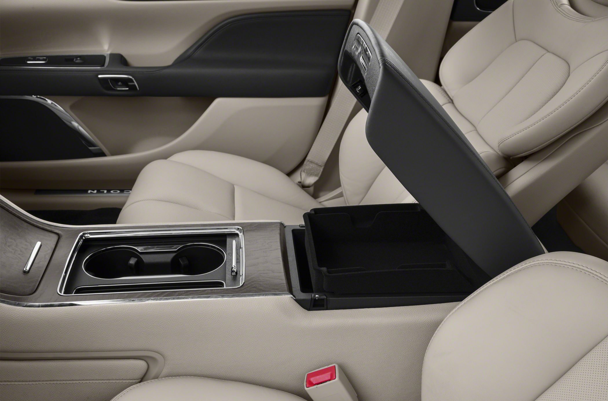Center console storage with cup holders and beige leather seats