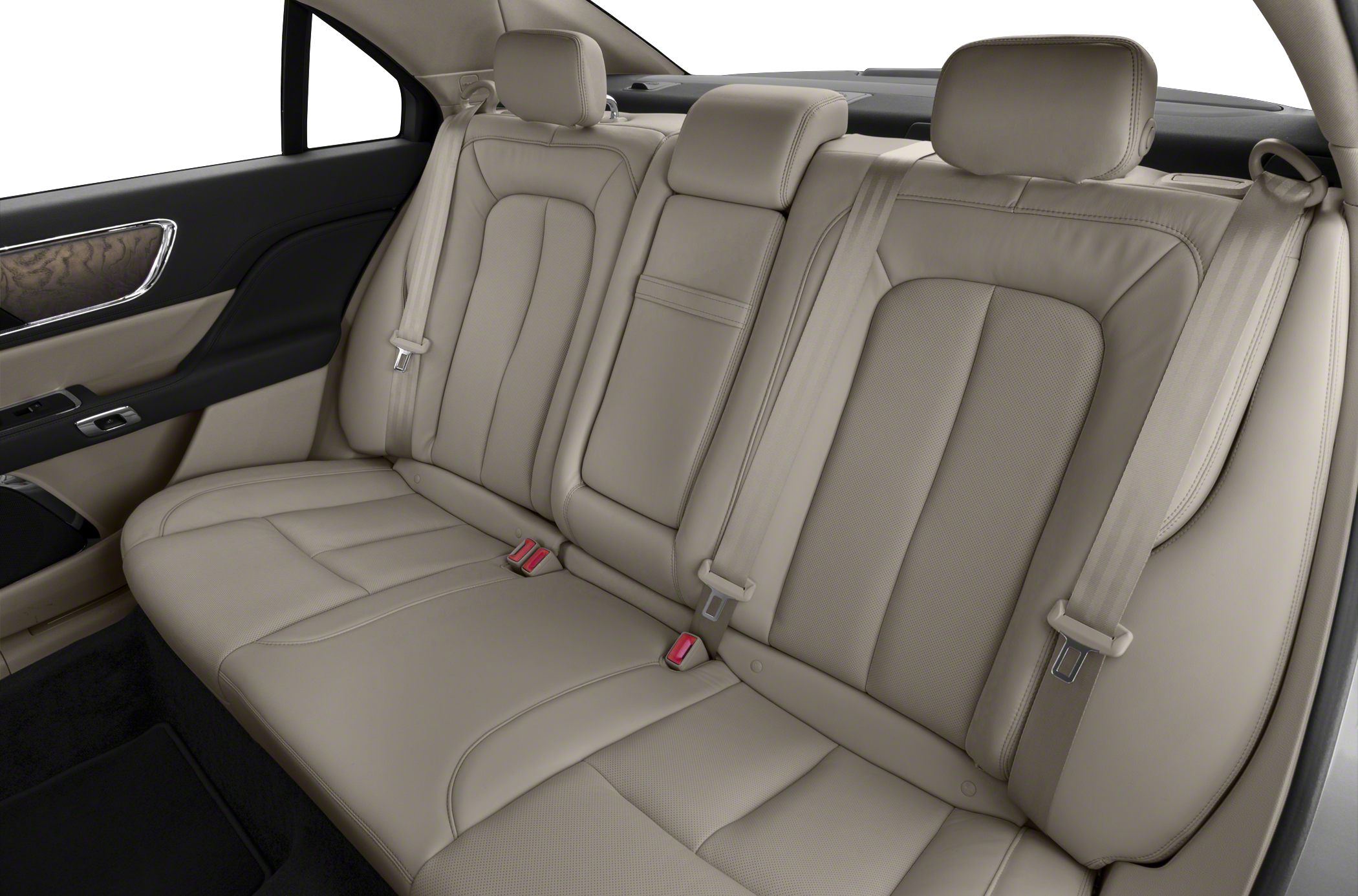 Beige leather rear seats with headrests and seat belts.