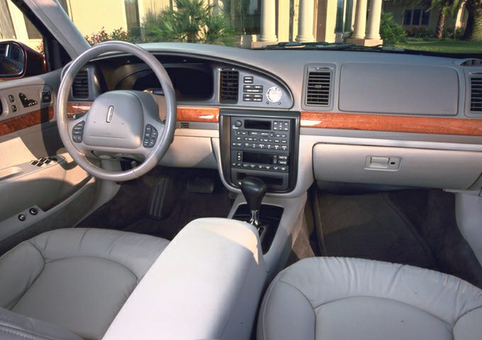 Leather seats and wood dashboard trim with center console and gear shifter