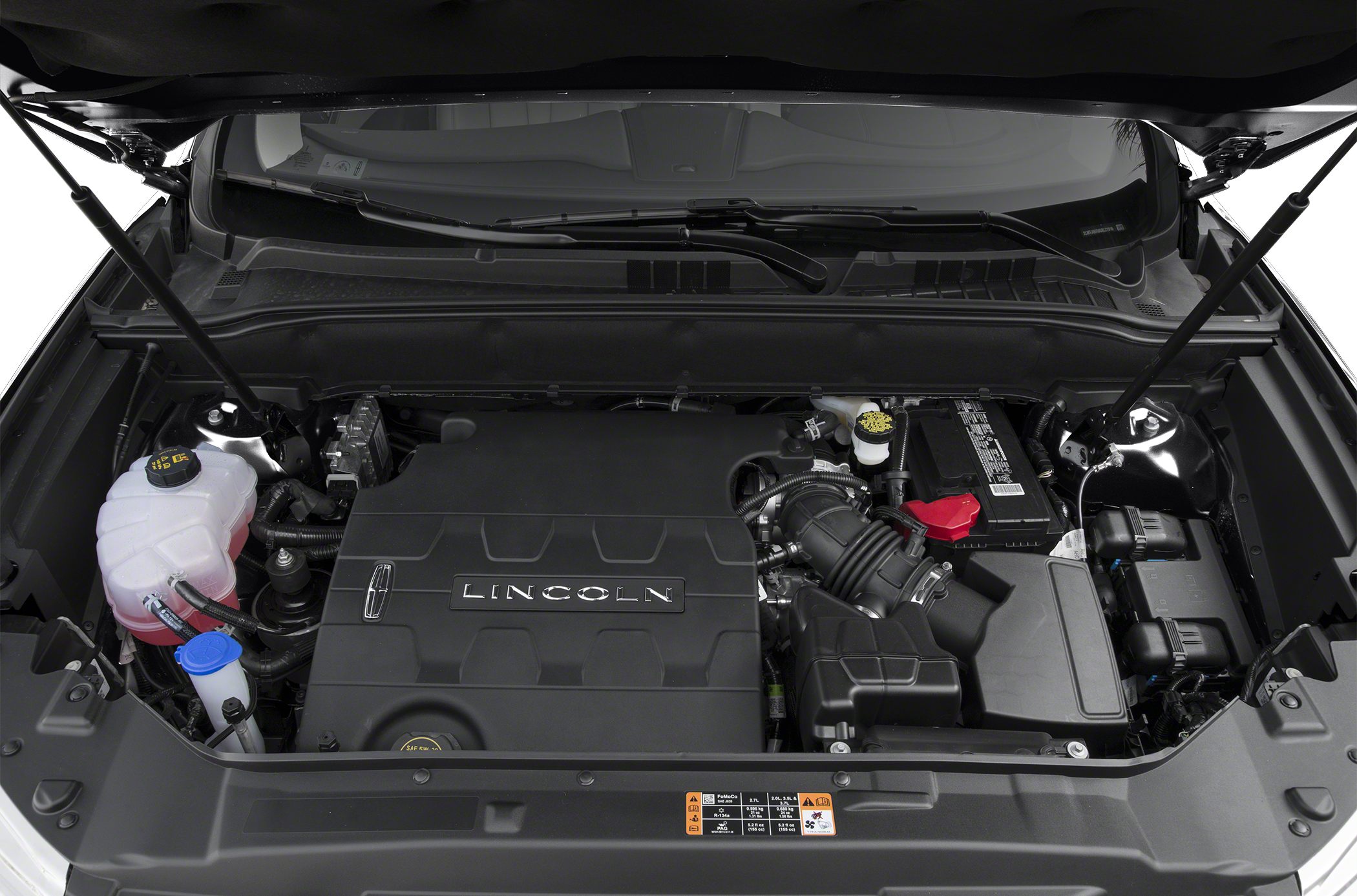Engine bay with covered engine and visible fluid reservoirs