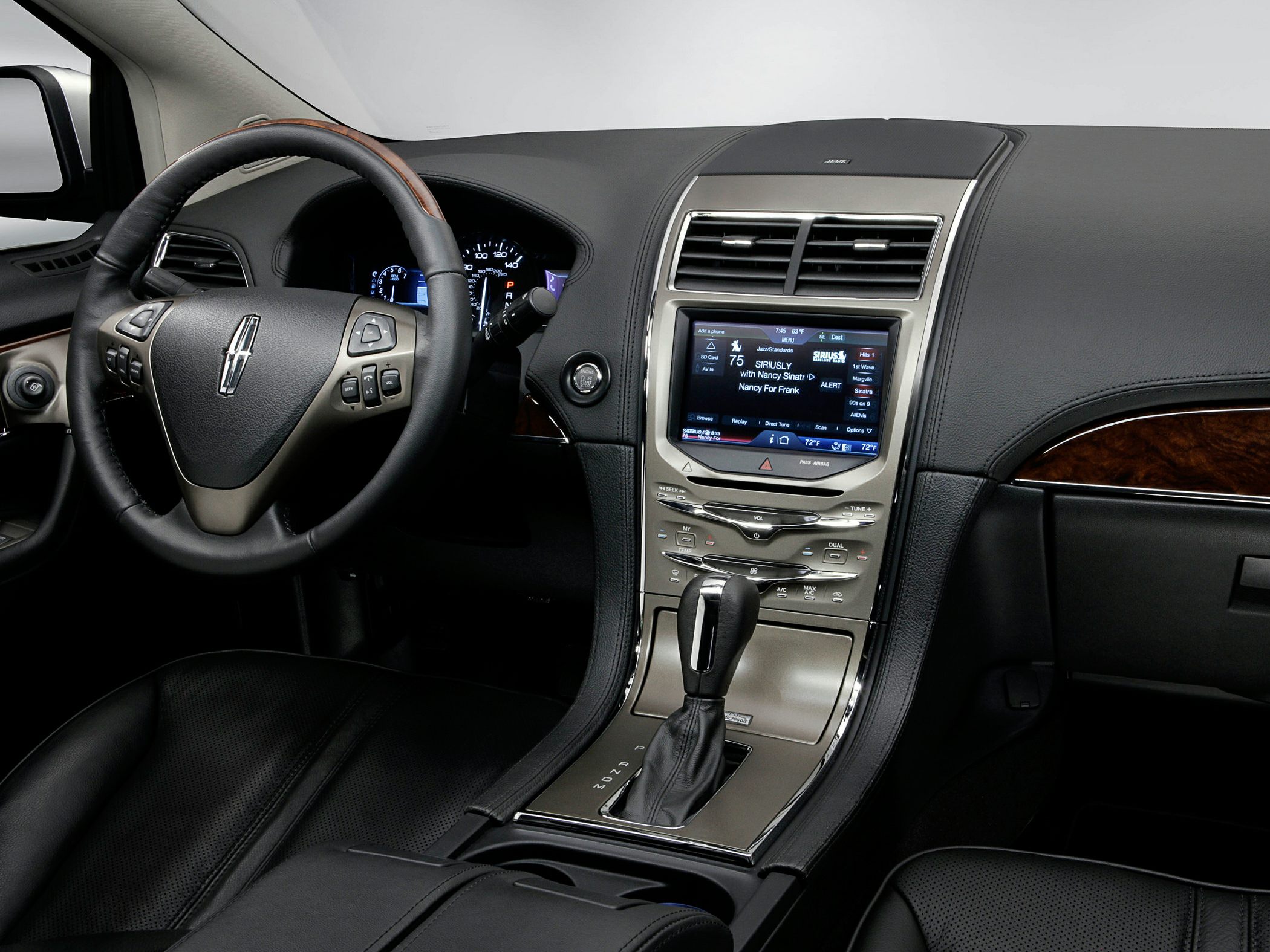 Touchscreen infotainment and multifunction steering wheel in upscale vehicle interior