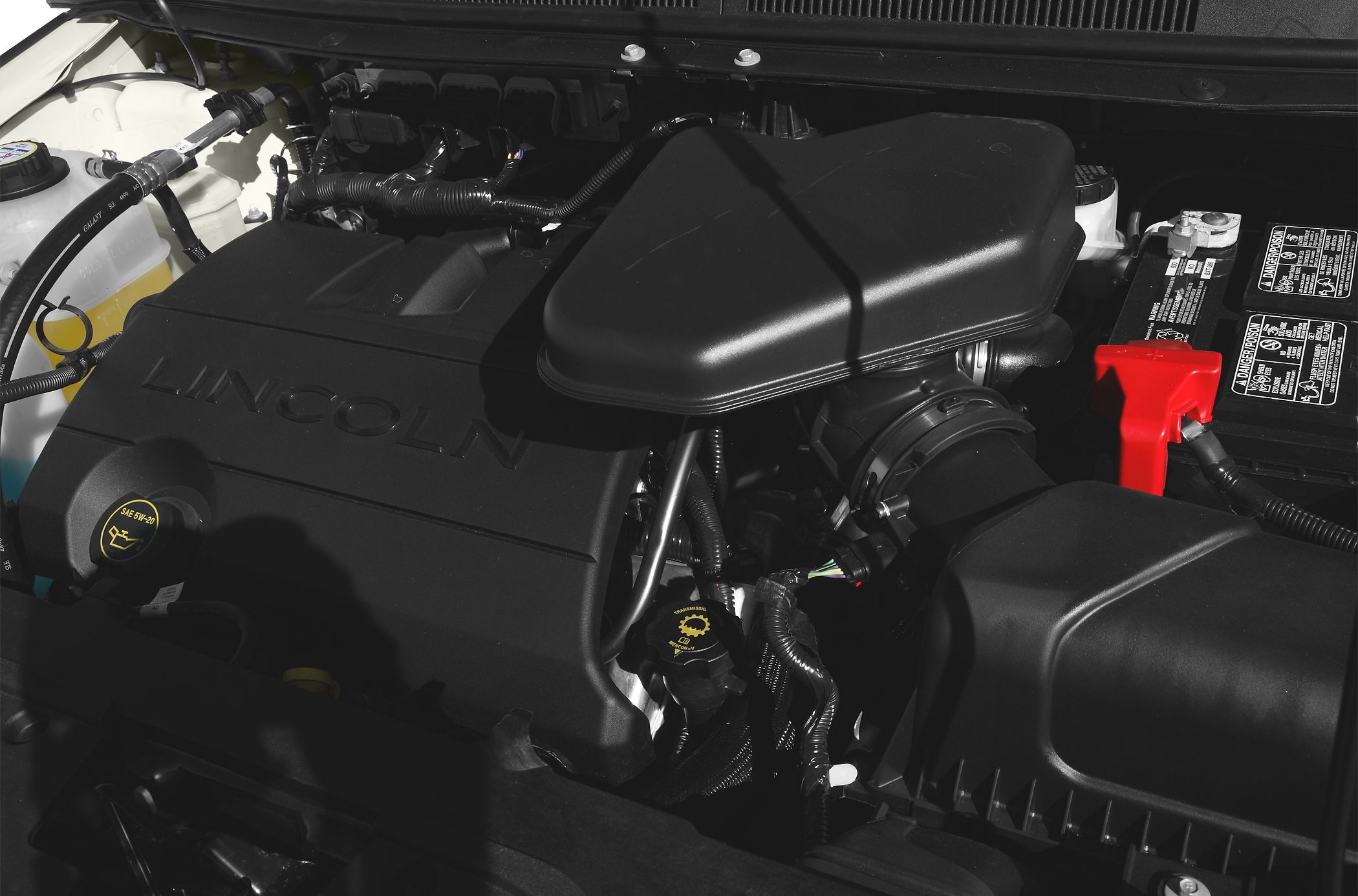 Close-up of engine bay with engine cover and air intake