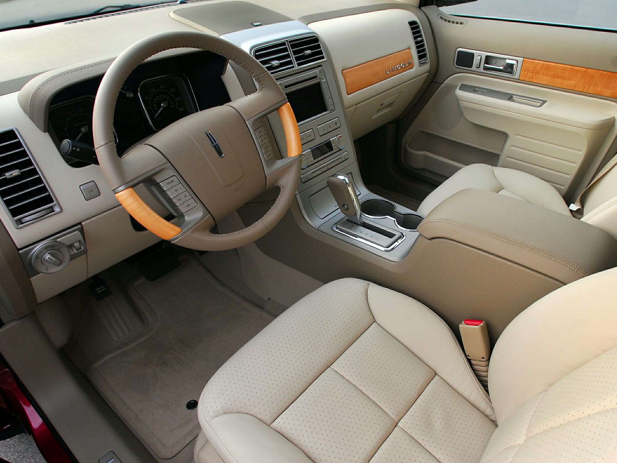 Beige leather seats with wood trim and leather steering wheel