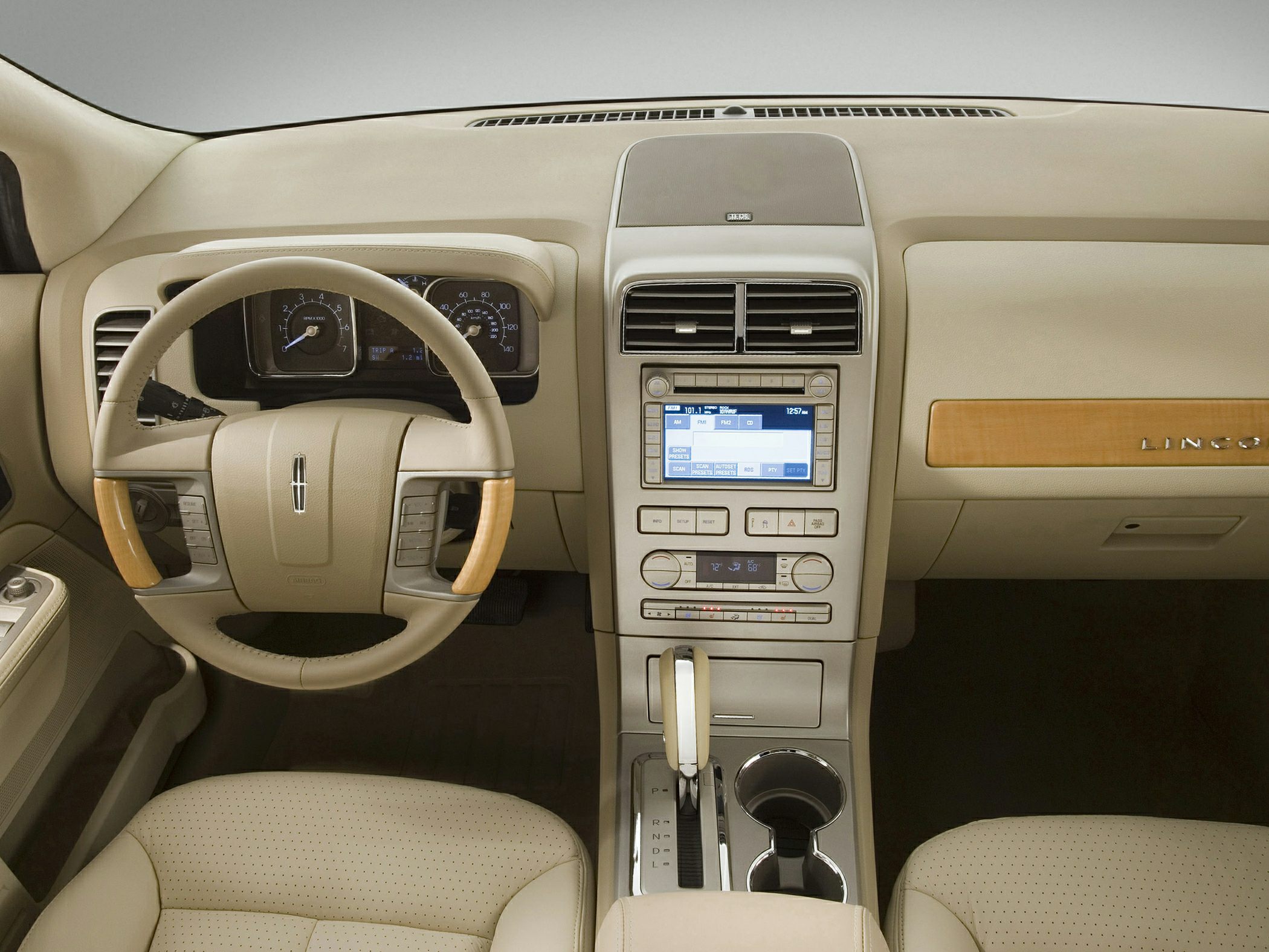 Beige dashboard with wood-accented steering wheel and center console