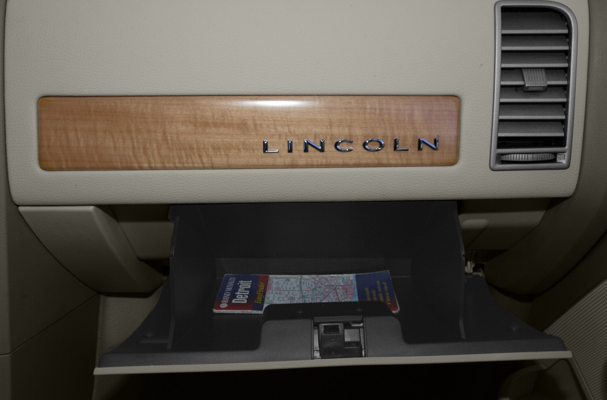 Wood trim and open glovebox with air vent