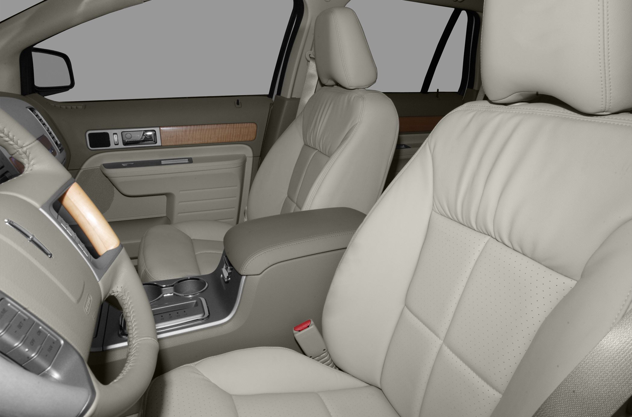 Beige leather front seats and center console with wood trim