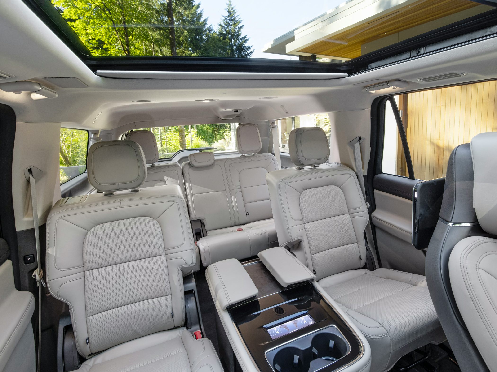 Spacious SUV interior with captain armchairs and panoramic sunroof