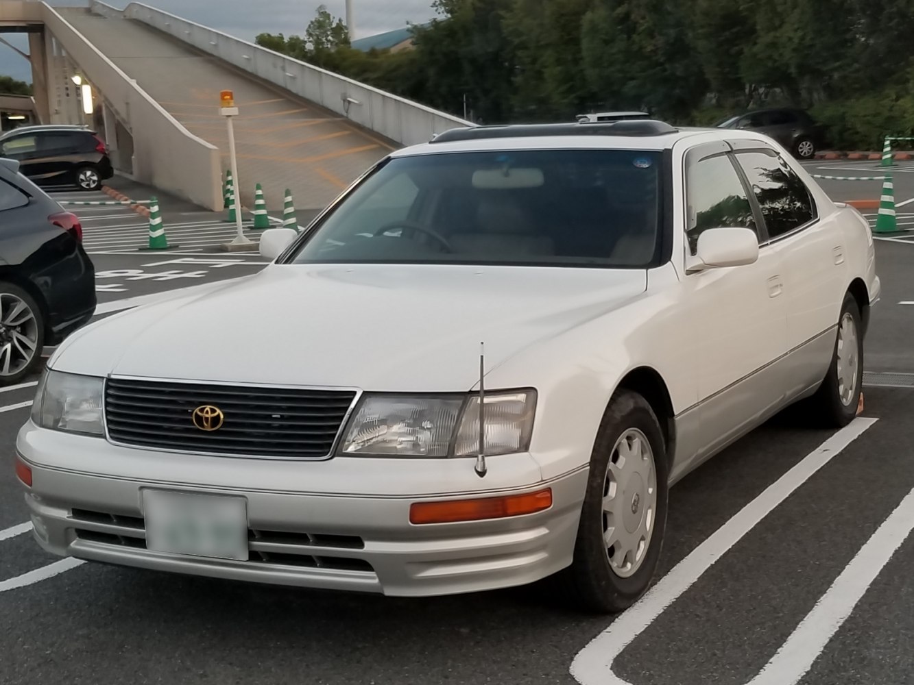 White 1990s sedan with distinct grille and headlamps
