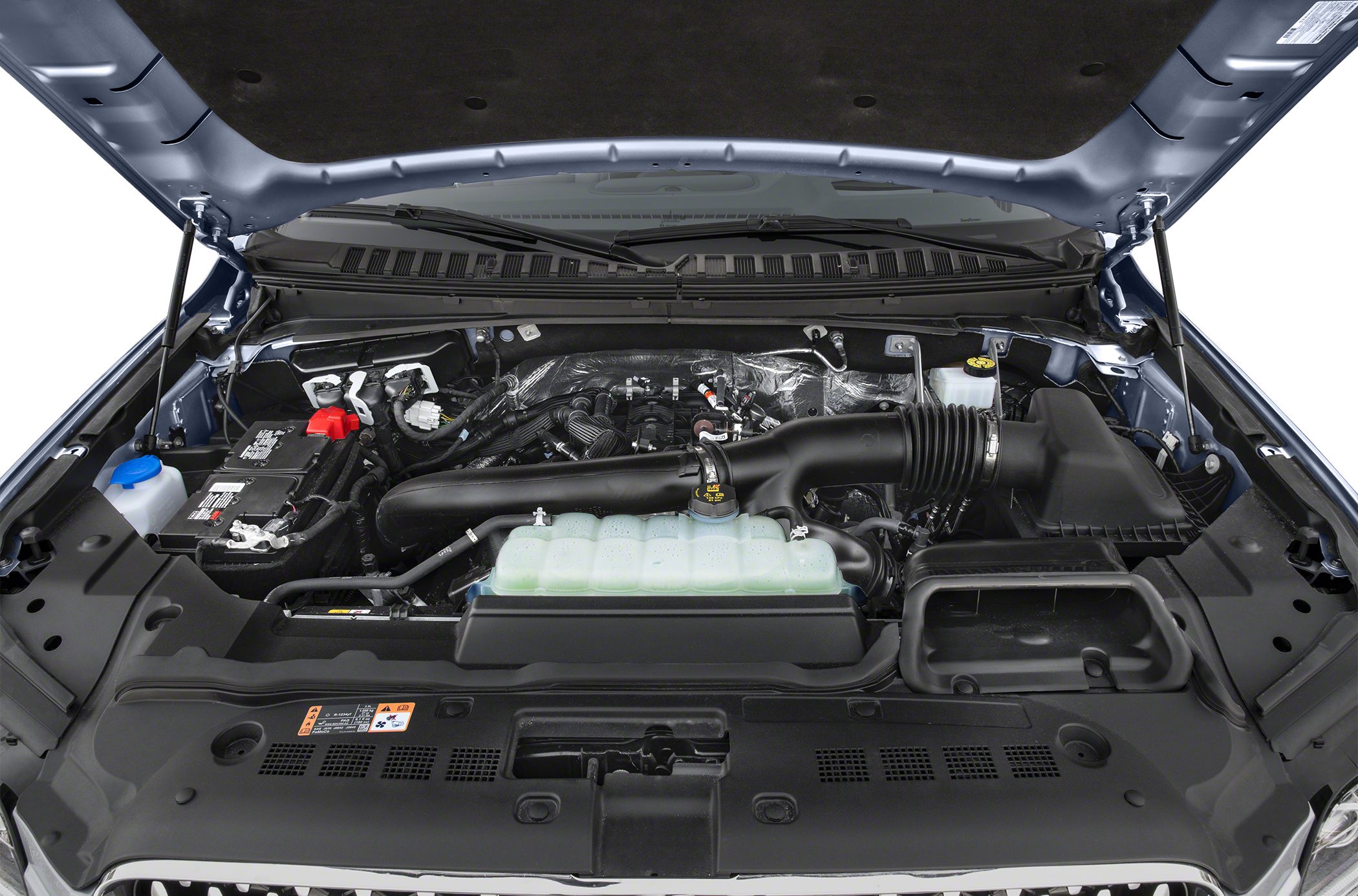 Engine bay with air intake and coolant reservoir