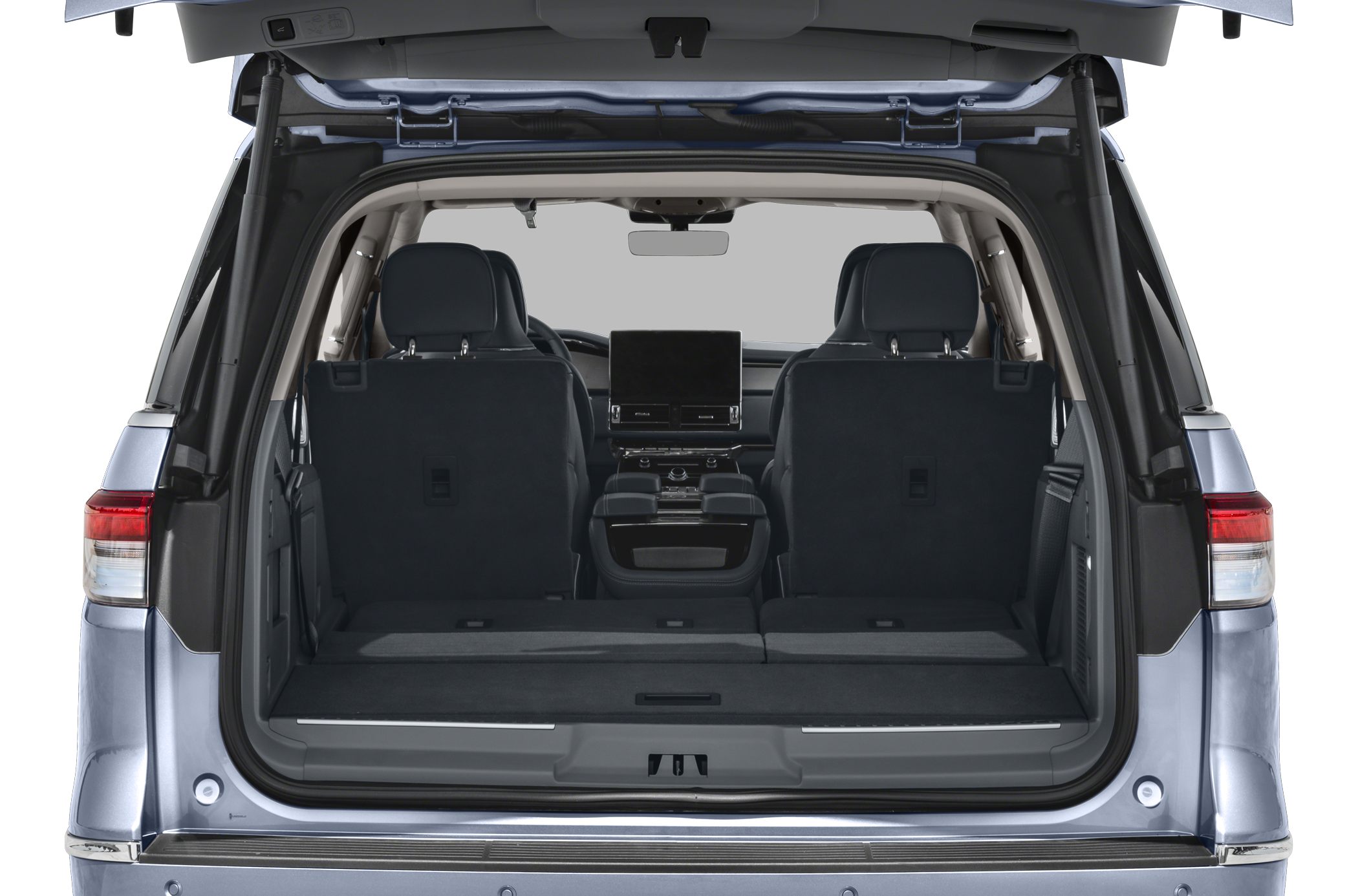 Rear cargo space with folded seats and central digital display in luxury SUV