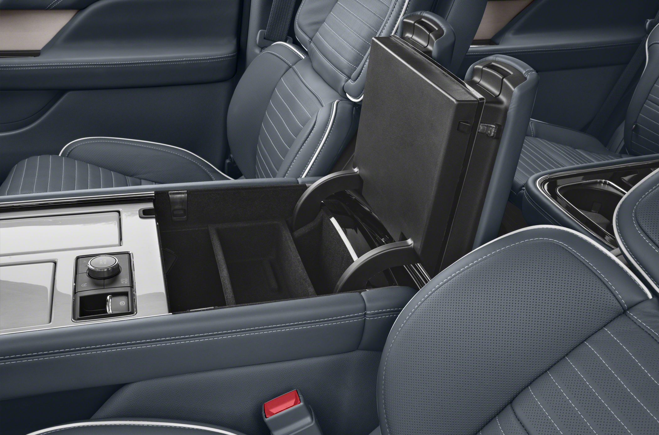 Center console storage with modern control knob and leather seats