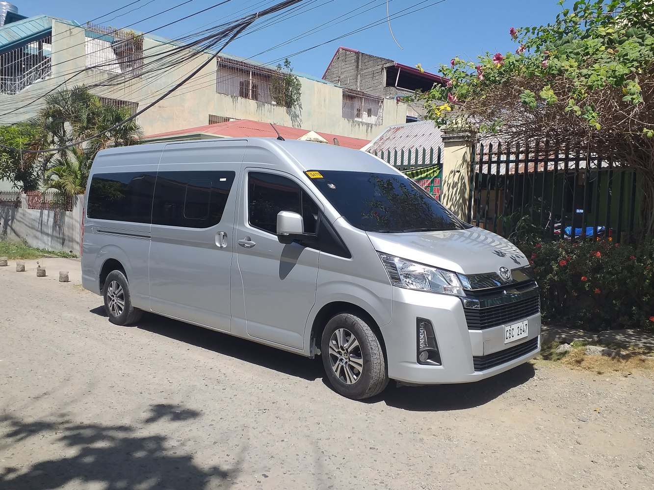 Silver large van with high roof and multiple side windows