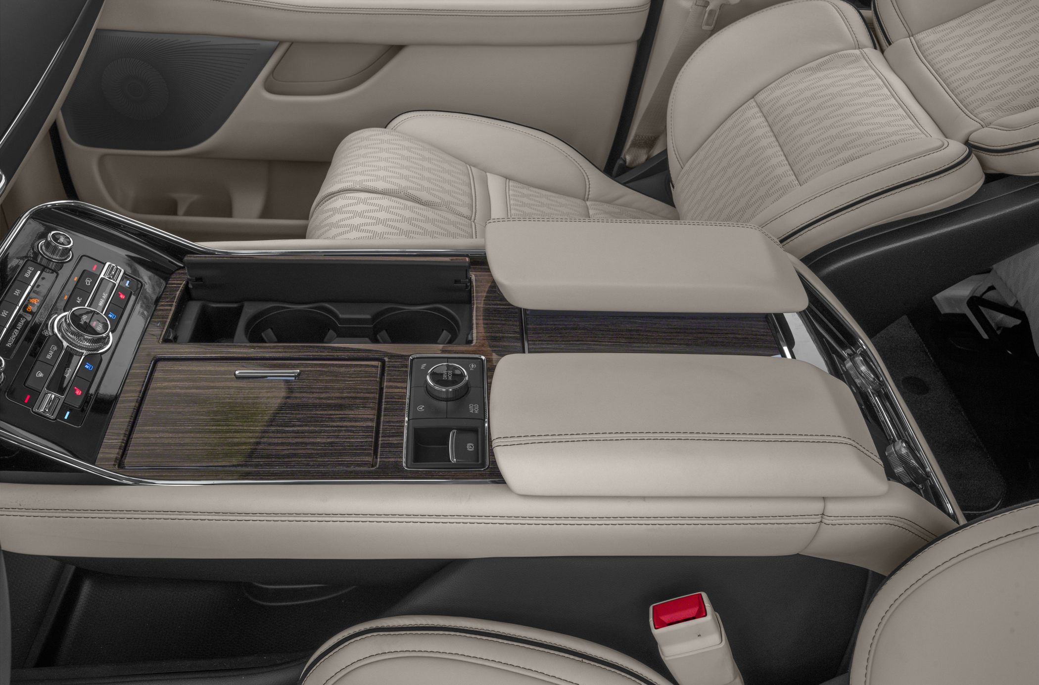 Beige leather seats with stitched detailing and wood grain center console