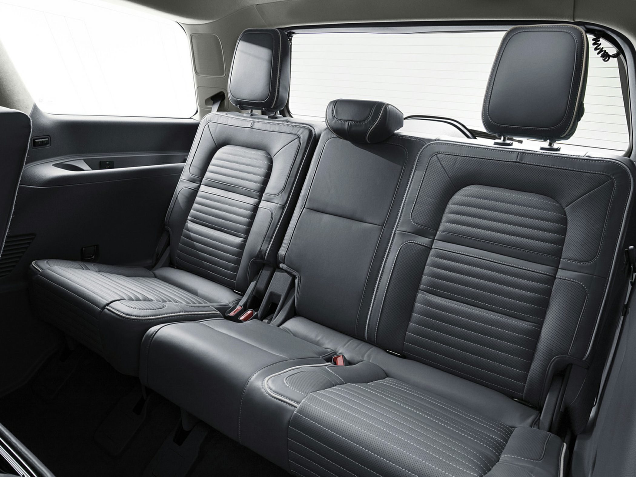 Black leather rear seats with stitching and headrests