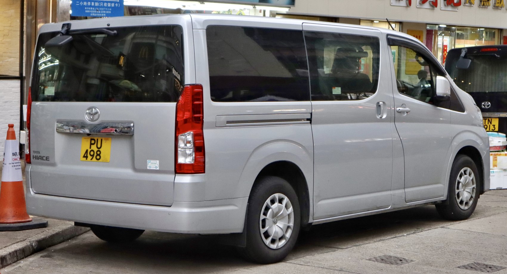Silver van rear and side with sliding door and vertical tail lights