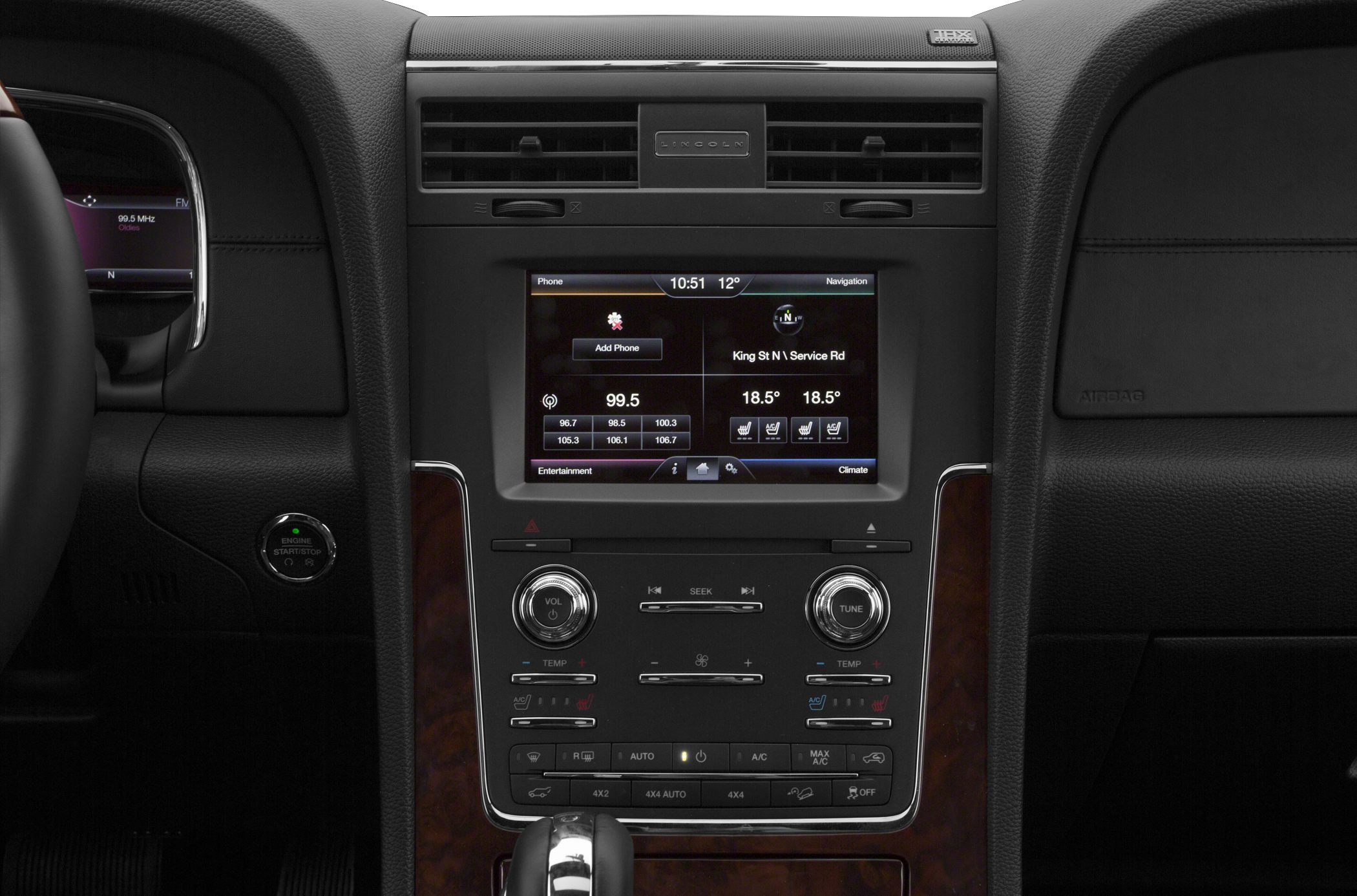 Infotainment screen with climate controls and radio tuning knobs