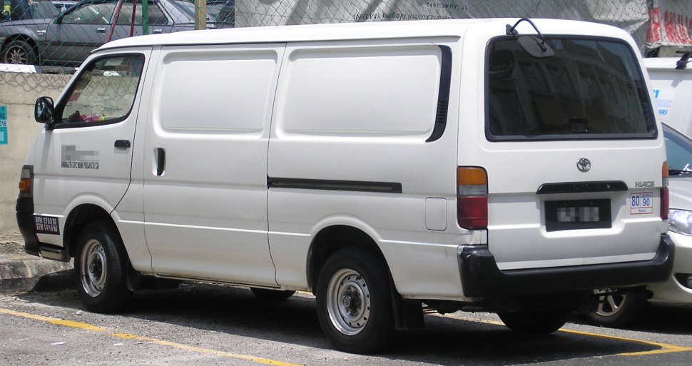 White cargo van with sliding side door and rear windows