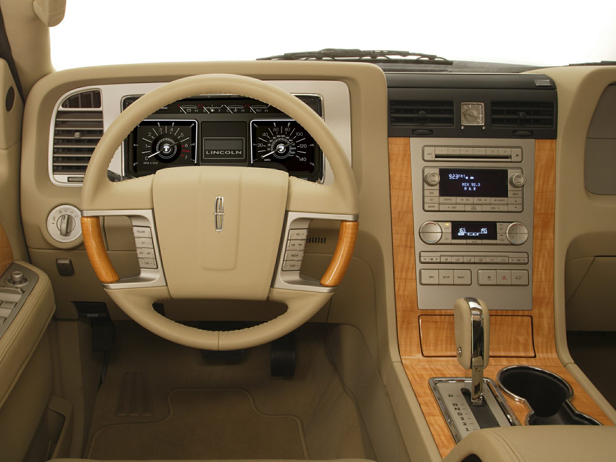 Beige SUV interior with wood trim and analog gauges