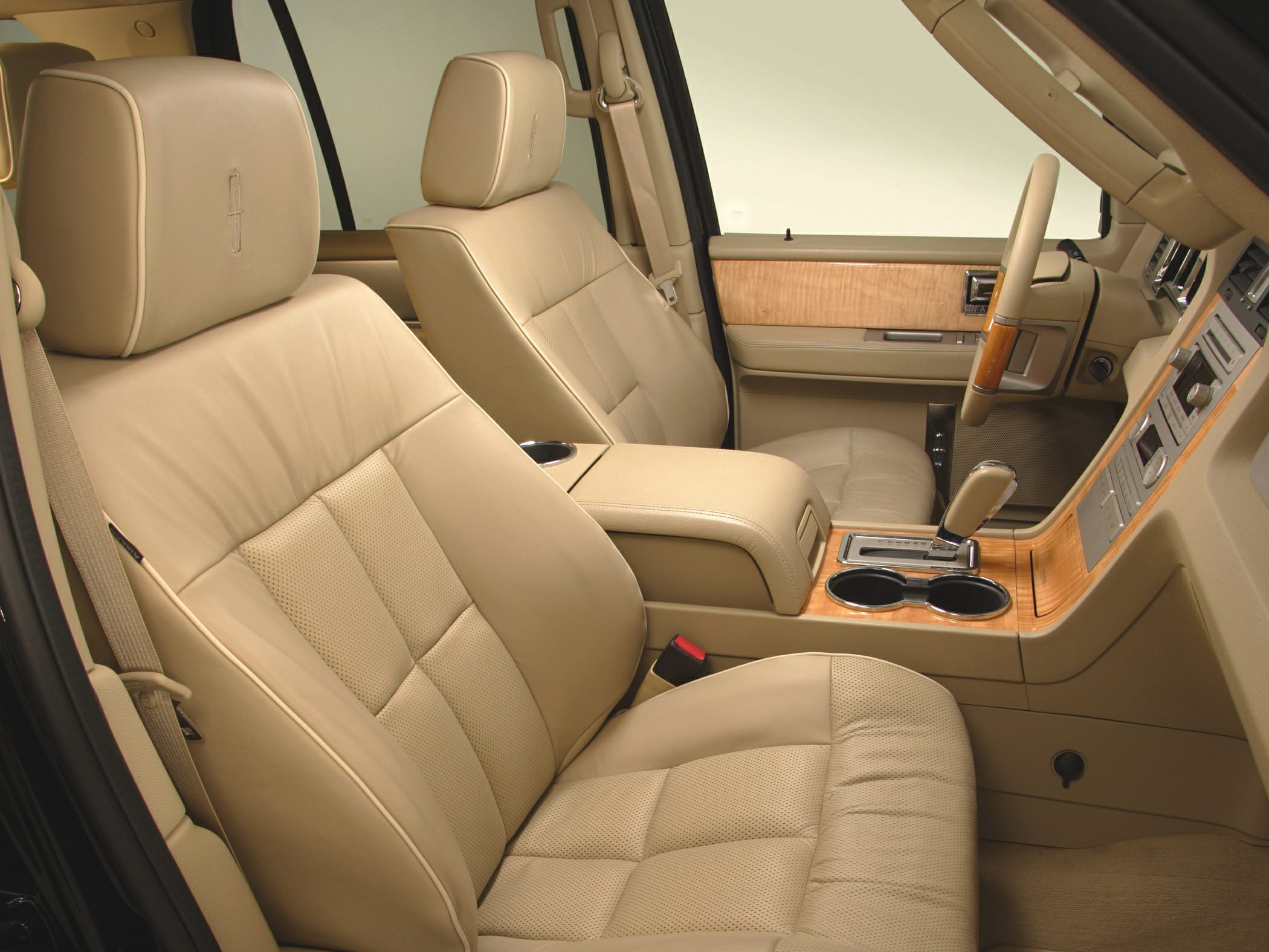 Tan leather seats and wood trim interior with center console and cup holders