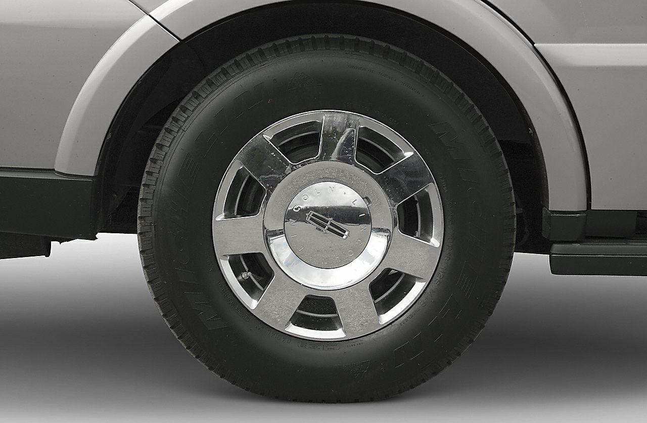 Close-up of a chrome alloy wheel with mounted tire on an SUV.