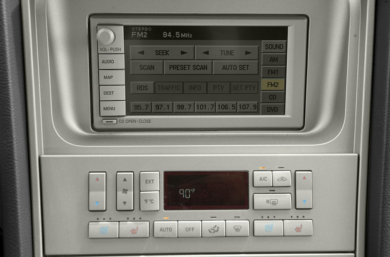Integrated FM radio and climate control panel with temperature display and seat heating buttons.