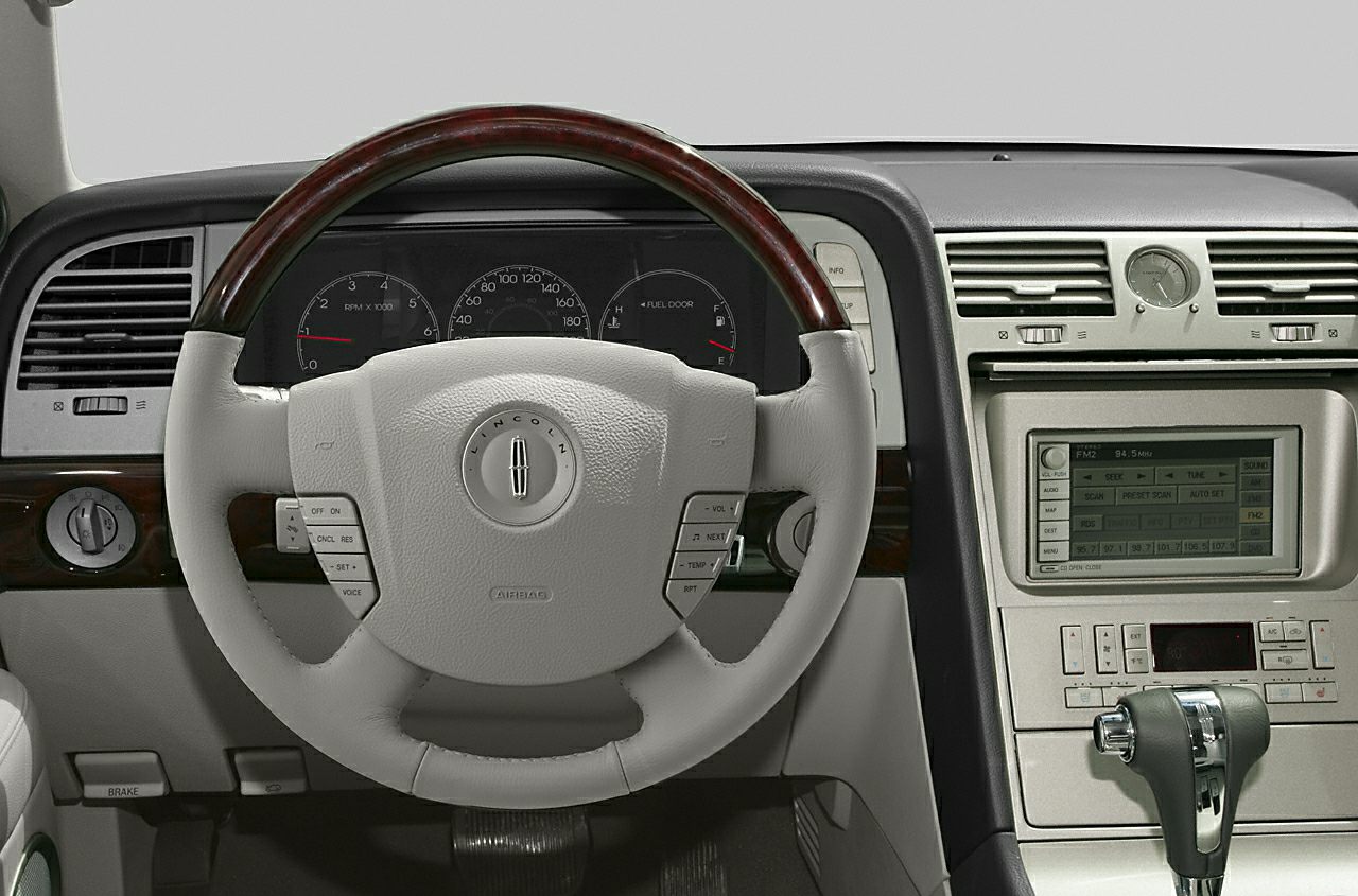 Wood-trimmed steering wheel, dashboard gauges, center console controls