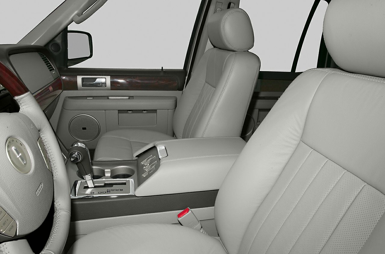 Leather seats and detailed dashboard interior with wood trim and center console.
