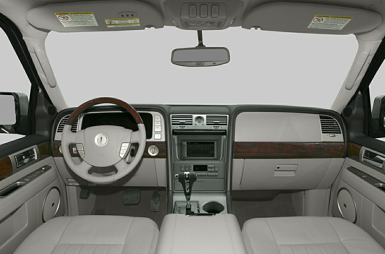 Luxury SUV dashboard and steering wheel with wood trim and center console