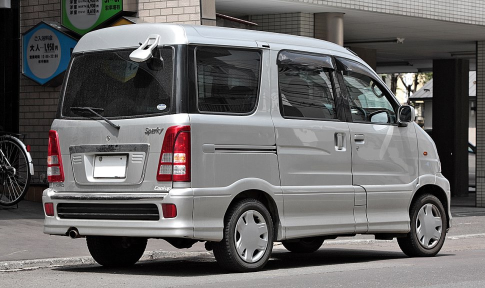 Compact silver mini van with sliding door and tinted windows