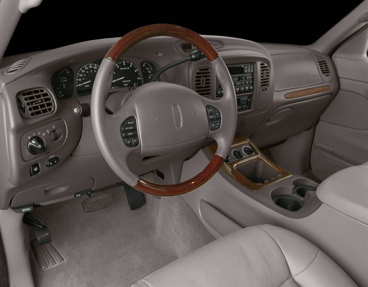 Wood-trimmed steering wheel and detailed dashboard with center console