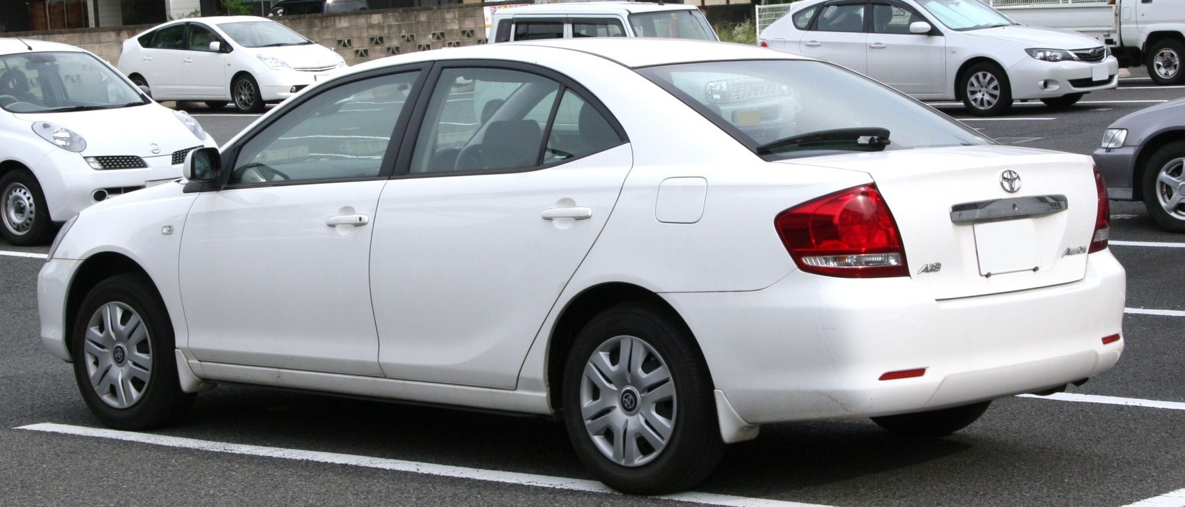 Rear side view and rear light design of white mid-size sedan