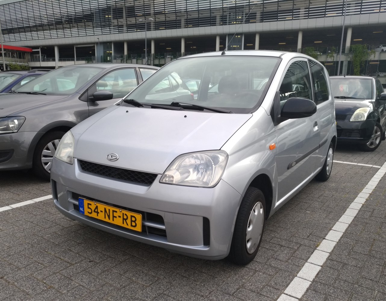 Compact hatchback with rounded headlights and simple grille